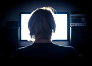 Man using his computer late into the night.